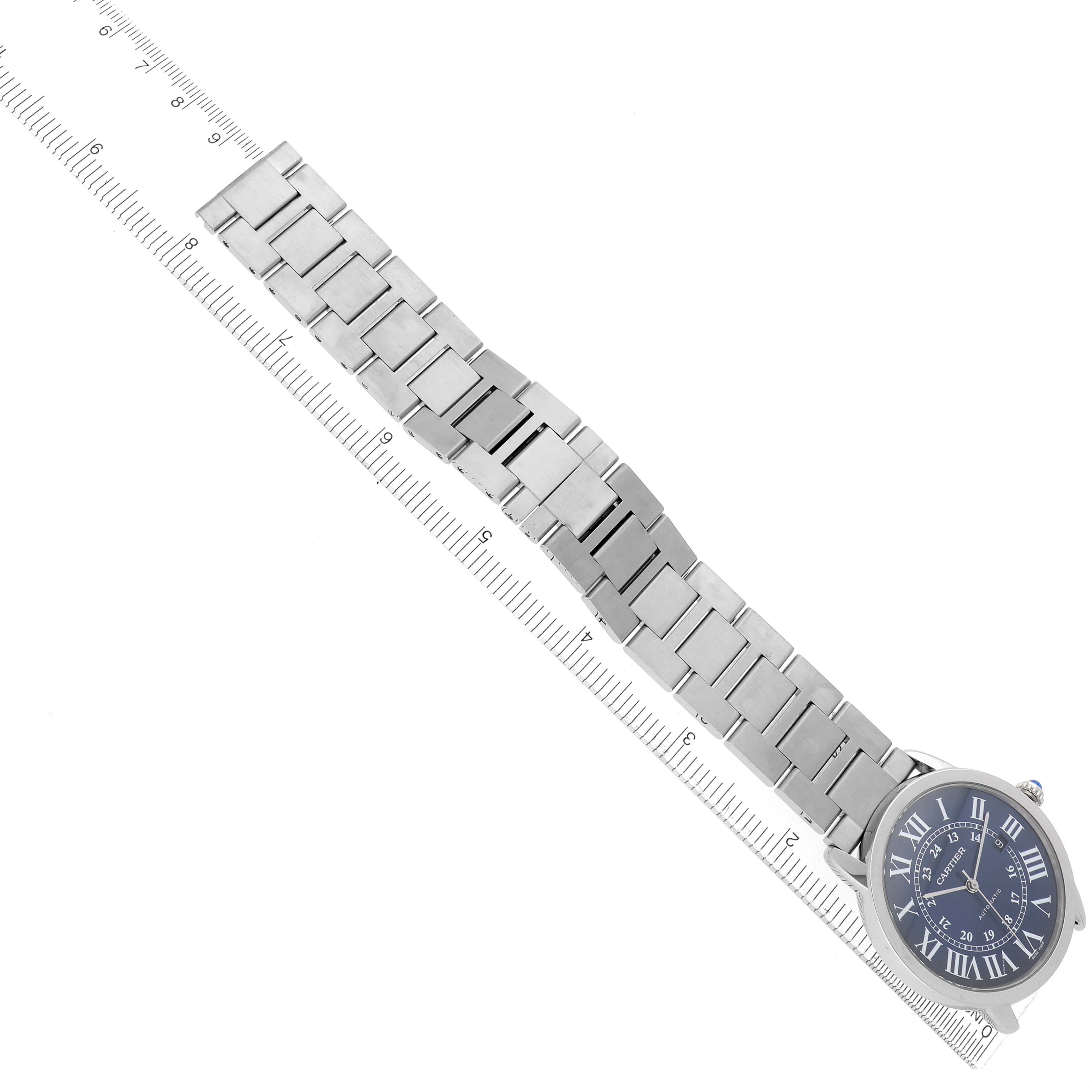 The image shows a Cartier Ronde WSRN0023 Men's Stainless Steel Blue Dial WSRN0023 Men's Stainless Steel Blue Dial watch at an angle, highlighting the strap and face alongside a measurement ruler.