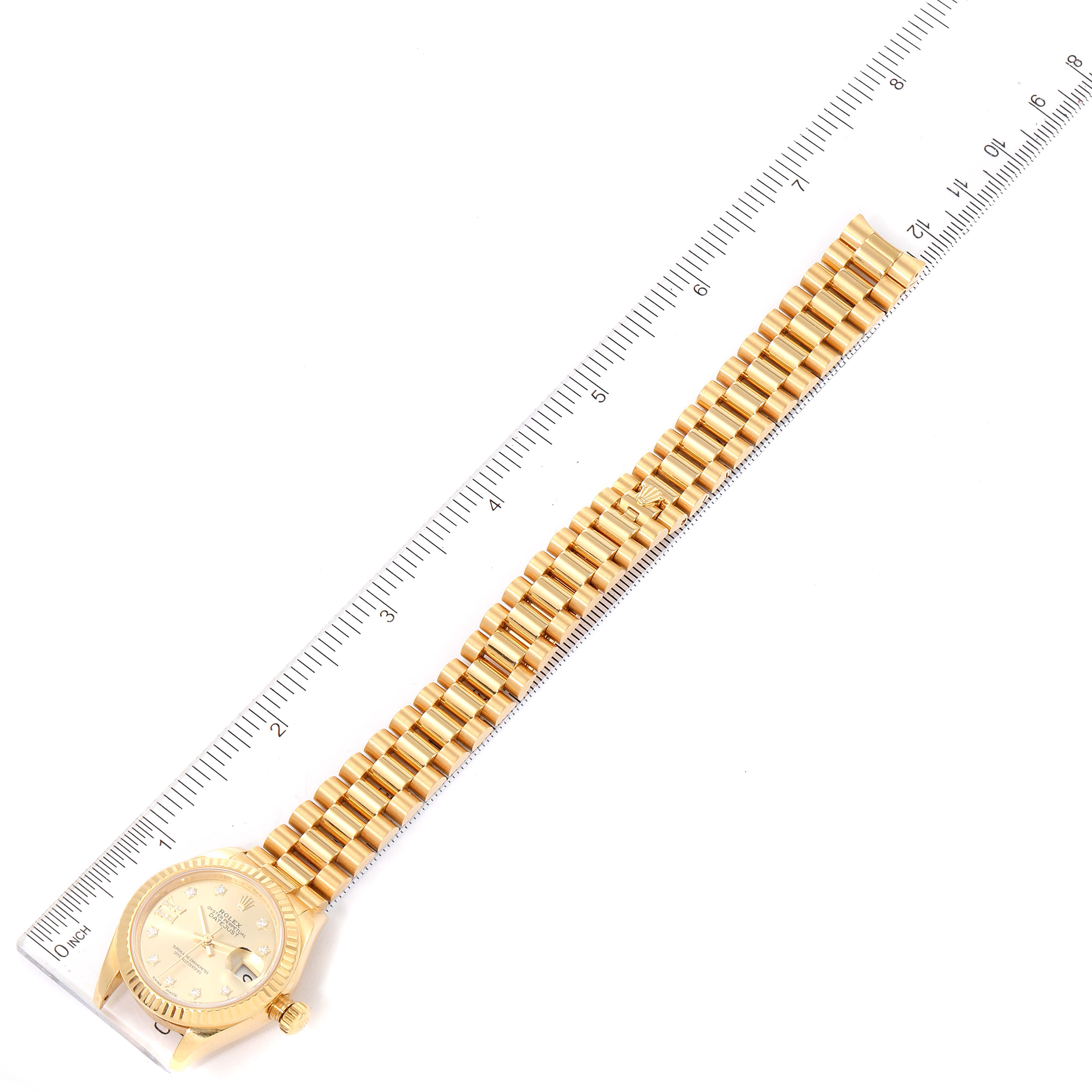 The image shows a Rolex President 279178 Women's Yellow Gold Champagne Dial 279178 Women's Yellow Gold Champagne Dial model watch laid flat with a ruler measuring its length.
