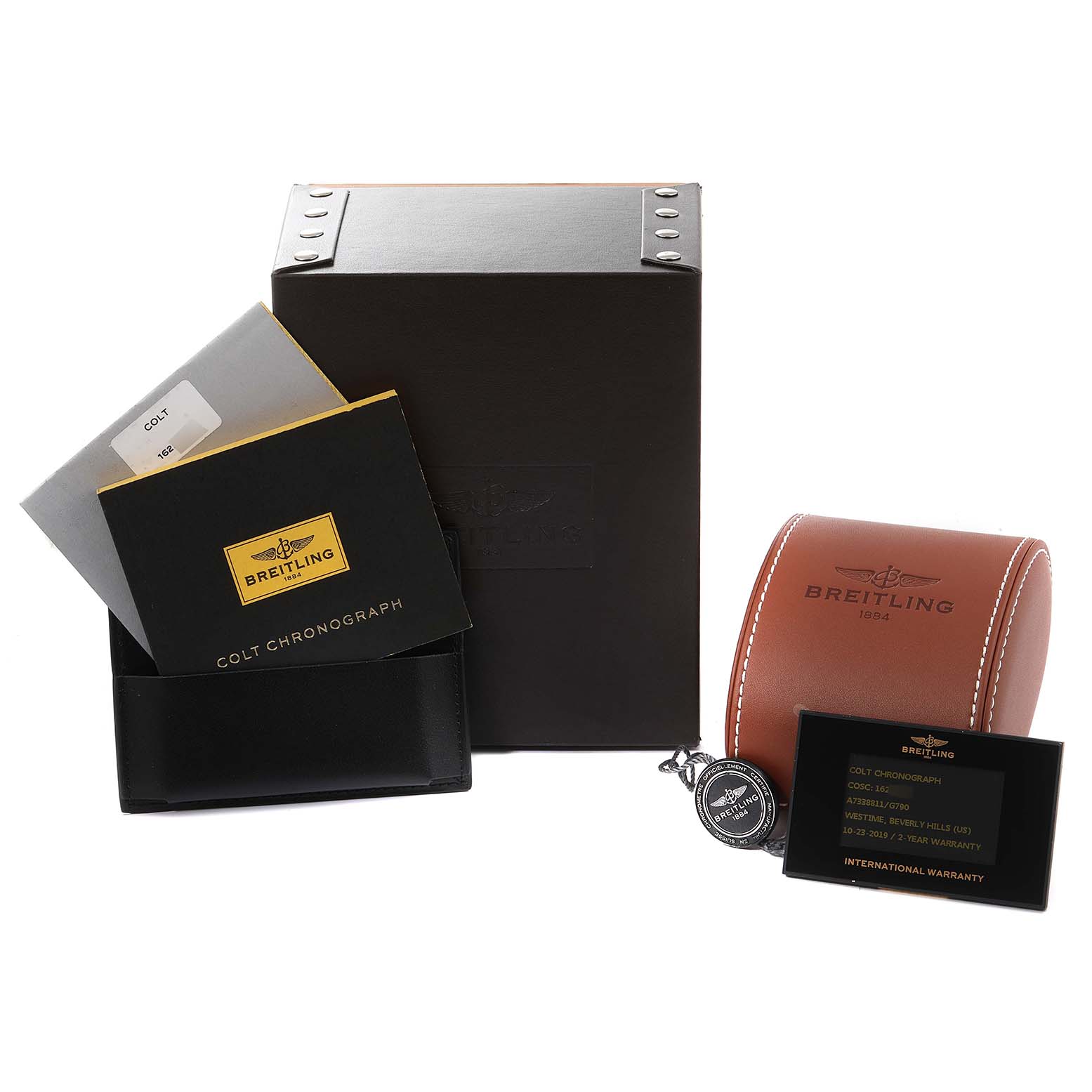 The image shows packaging and accessories of the Breitling Colt A73388 Men's Stainless Steel White Dial A73388 Men's Stainless Steel White Dial watch model, including a box, manuals, a case, and a warranty card.