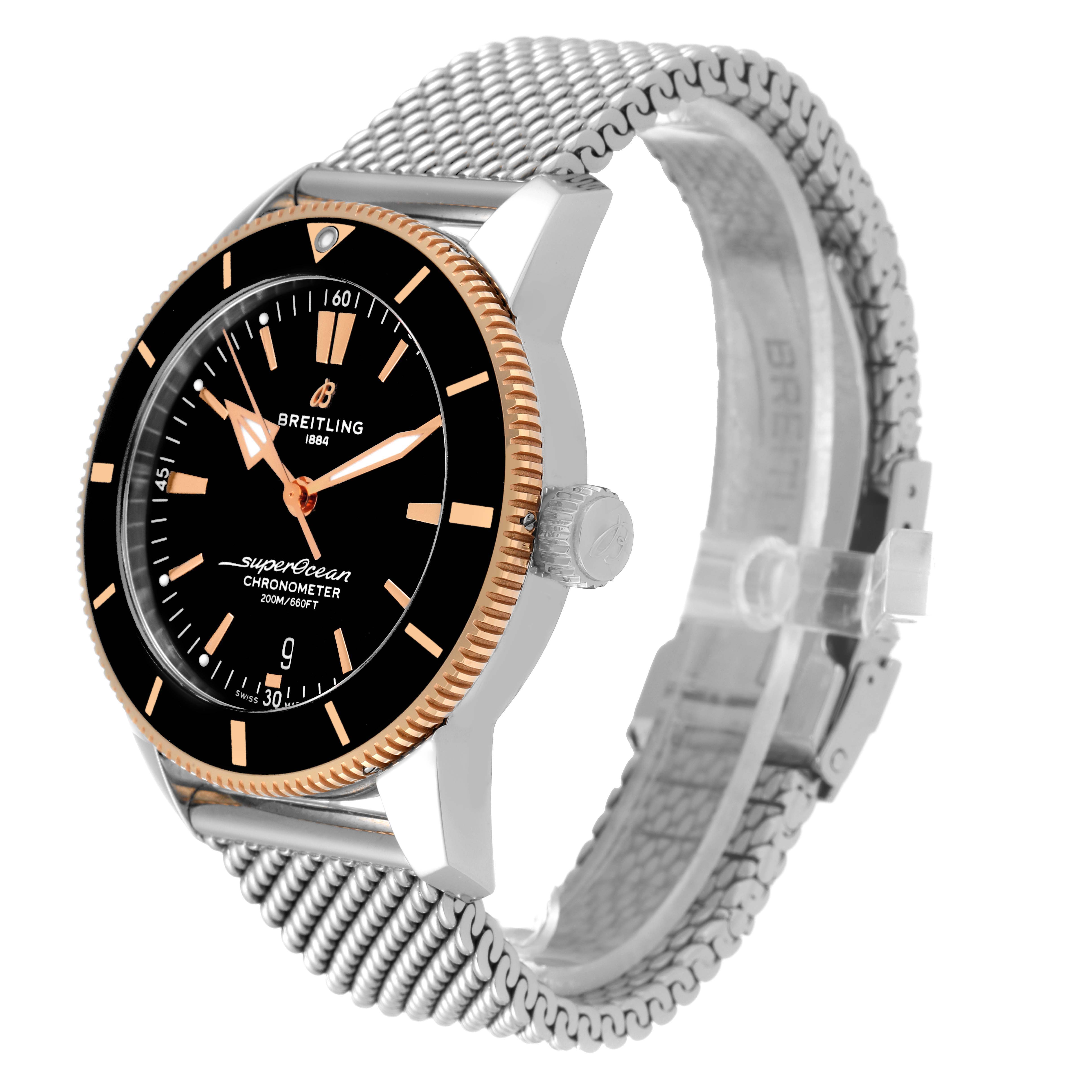 The Breitling Superocean UB2030121B1A1 Men's Steel and Gold (two tone) Black Dial UB2030121B1A1 Men's Steel and Gold (two tone) Black Dial watch is shown at an angle displaying the dial, bezel, and metal mesh bracelet.