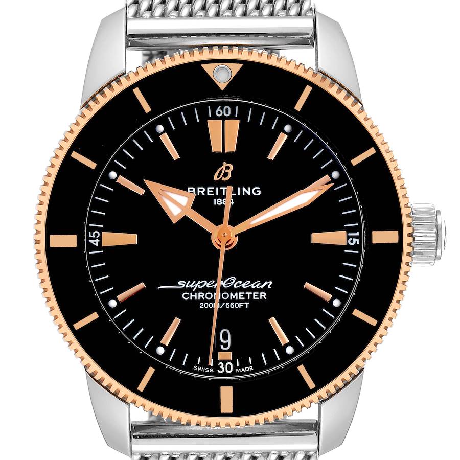 This is a front view of the Breitling Superocean UB2030121B1A1 Men's Steel and Gold (two tone) Black Dial UB2030121B1A1 Men's Steel and Gold (two tone) Black Dial watch, showcasing its black dial, gold accents, and a metal mesh strap.