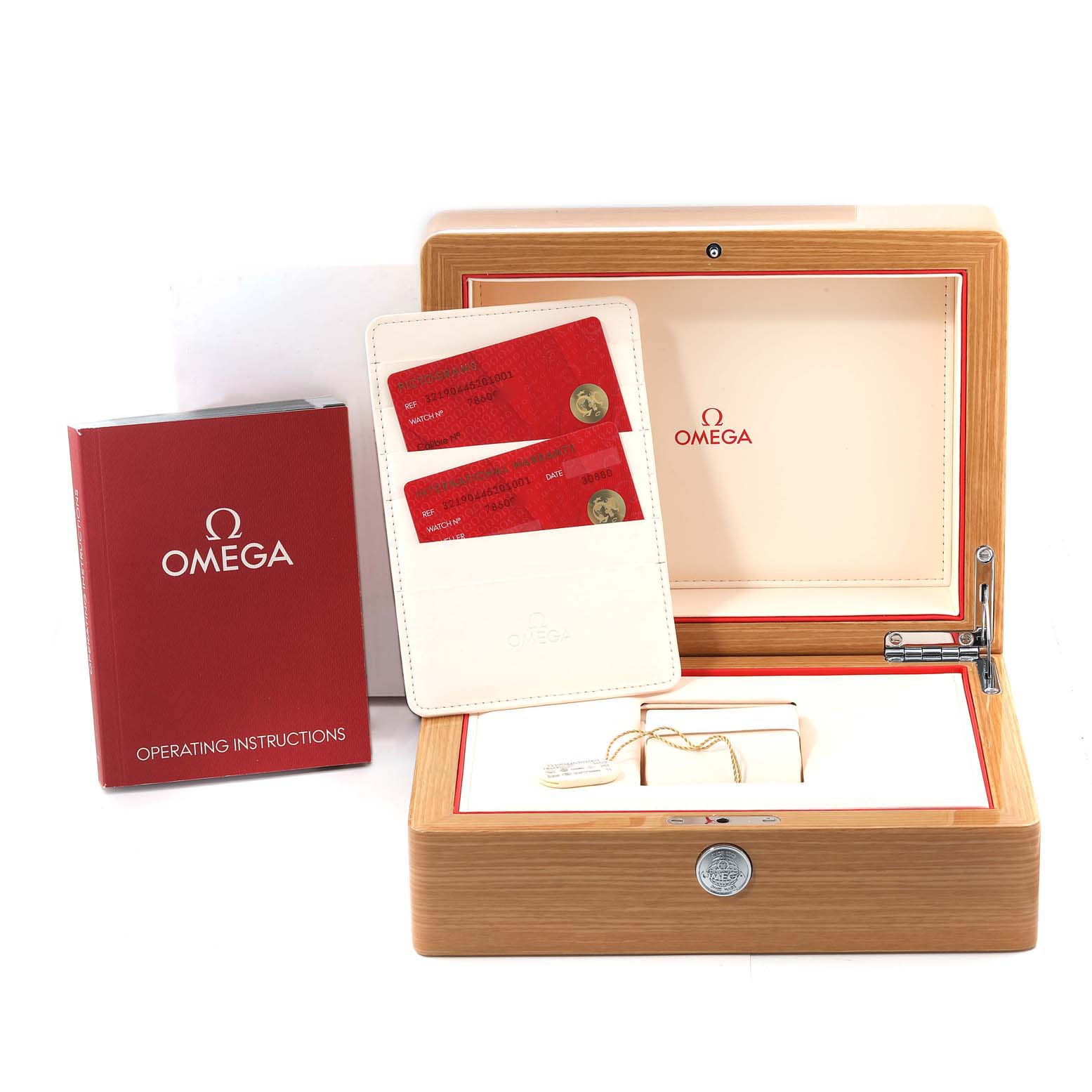 The image shows an Omega Speedmaster 321.90.44.52.01.001 Men's Titanium Black Dial 321.90.44.52.01.001 Men's Titanium Black Dial watch box, operating instructions, and warranty cards from a front angle.