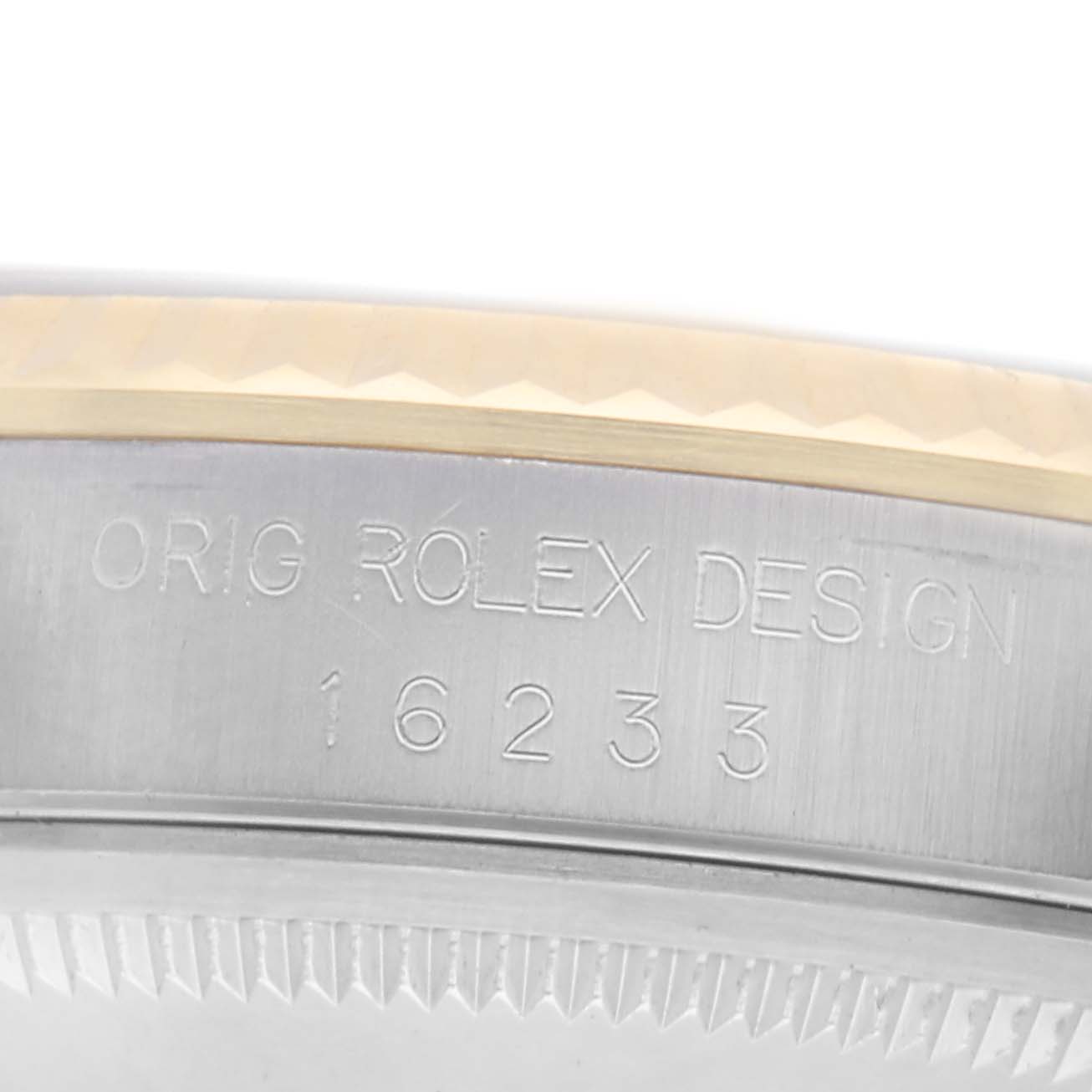 The image shows a close-up of the side of a Rolex Datejust 16233 Men's Steel and Gold (two tone) White Dial 16233 Men's Steel and Gold (two tone) White Dial watch, highlighting the engraved model and design numbers on the case.