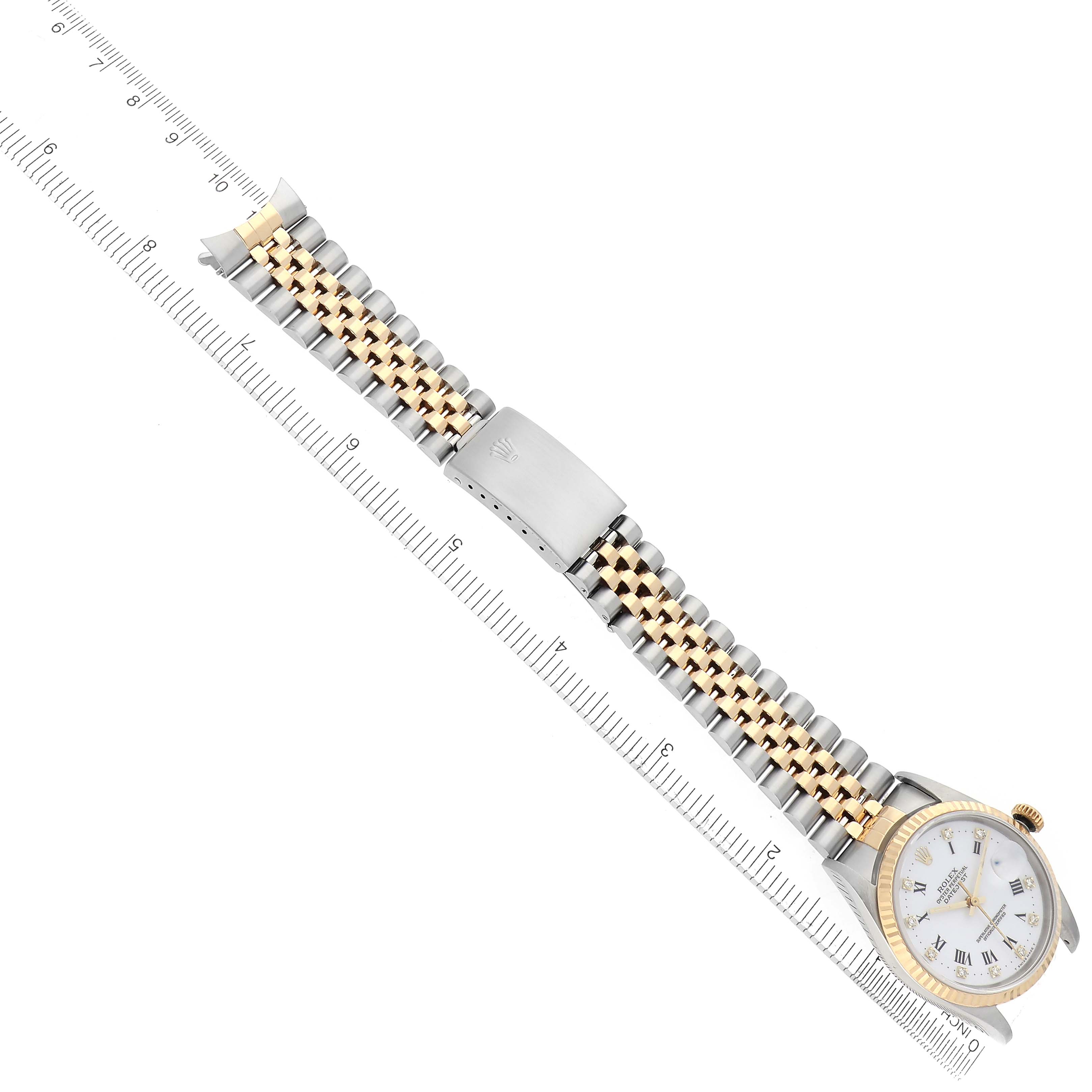 The Rolex Datejust 16233 Men's Steel and Gold (two tone) White Dial 16233 Men's Steel and Gold (two tone) White Dial watch is shown from a top-down angle, displaying the bracelet, clasp, and watch face with a ruler next to it.