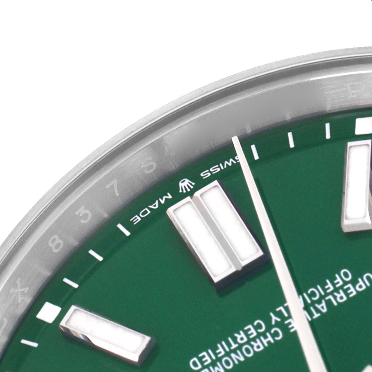 This image shows a close-up of the dial and bezel of a Rolex Oyster Perpetual 124300 Men's Stainless Steel Green Dial 124300 Men's Stainless Steel Green Dial watch, featuring hour markers and "Swiss Made" text.