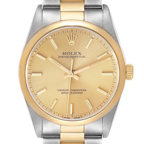 The Rolex Oyster Perpetual 14203 Men's Steel and Gold (two tone) Champagne Dial 14203 Men's Steel and Gold (two tone) Champagne Dial watch is shown from a front angle, featuring its face, bezel, and part of the bracelet.