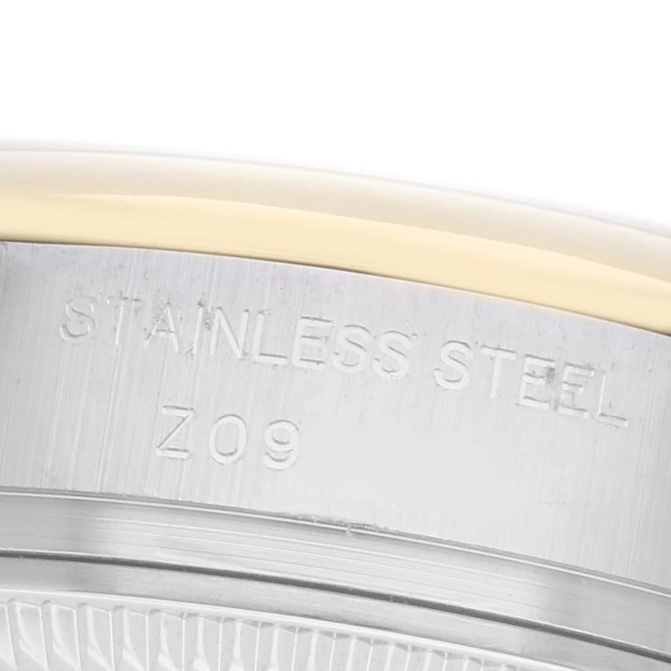 The image shows a close-up of the side view of a Rolex Datejust 179163 Women's Steel and Gold (two tone) Grey Dial 179163 Women's Steel and Gold (two tone) Grey Dial, highlighting the stainless steel case with an engraving.