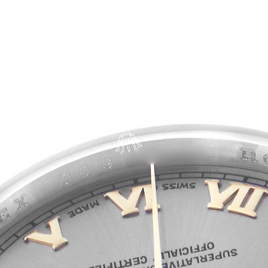 The image shows a close-up of the Rolex Datejust 179163 Women's Steel and Gold (two tone) Grey Dial 179163 Women's Steel and Gold (two tone) Grey Dial's dial and bezel, highlighting the Roman numerals and text details.