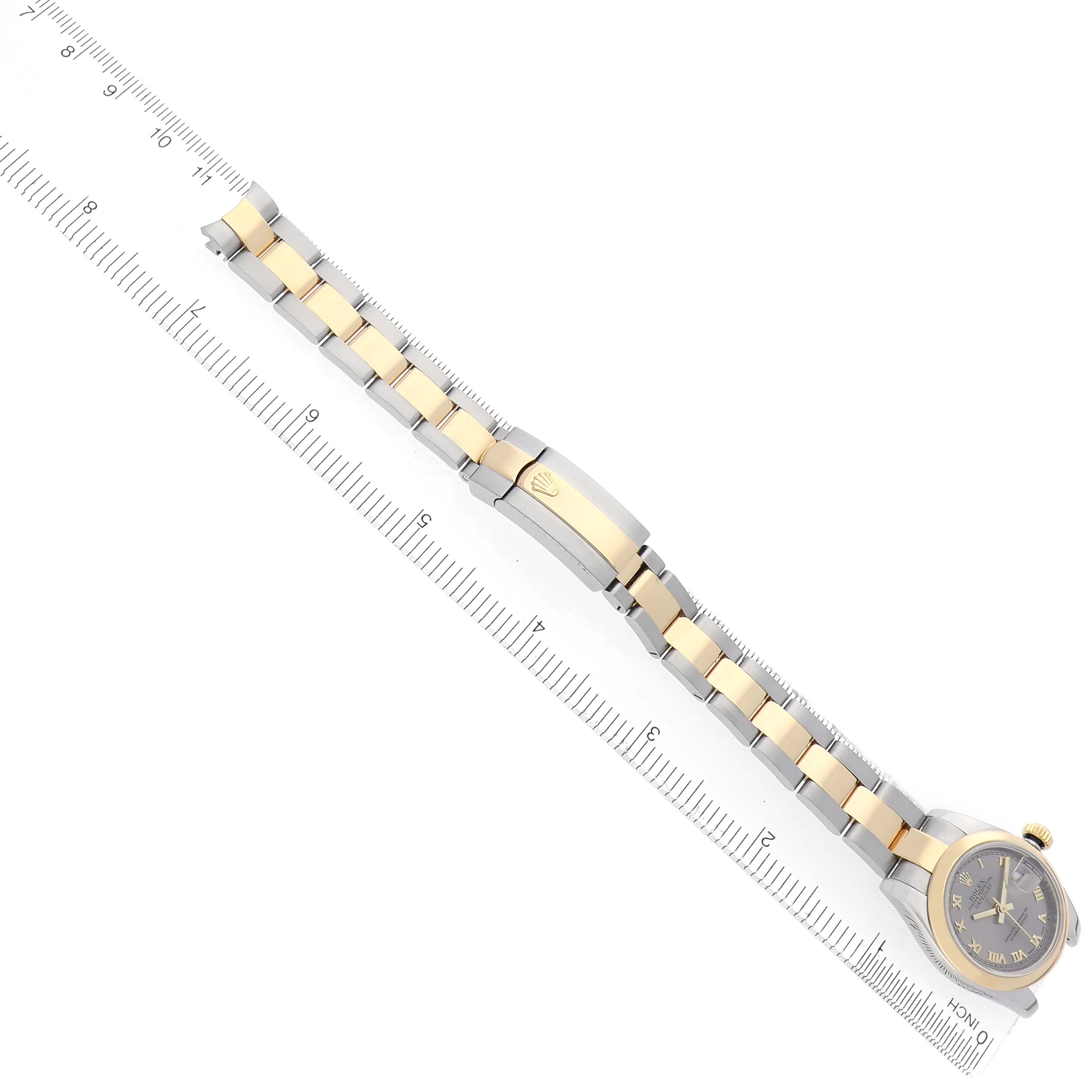 The Rolex Datejust 179163 Women's Steel and Gold (two tone) Grey Dial 179163 Women's Steel and Gold (two tone) Grey Dial watch is shown at an angle displaying the full bracelet, clasp, and face, with a ruler for size reference.