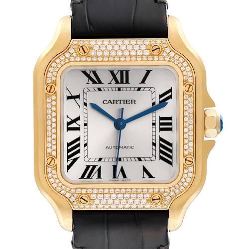 The image shows a front view of the Cartier Santos WJSA0008 Men's Yellow Gold Silver Dial WJSA0008 Men's Yellow Gold Silver Dial watch, featuring its face, bezel with diamonds, and part of its black strap.