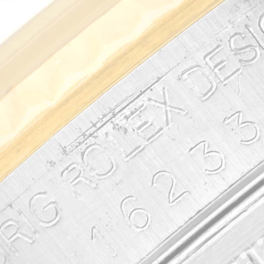 This close-up image shows the engraved inner bezel of a Rolex Datejust 16233 Men's Steel and Gold (two tone) Beige Dial 16233 Men's Steel and Gold (two tone) Beige Dial watch, displaying part of the brand name and model number.