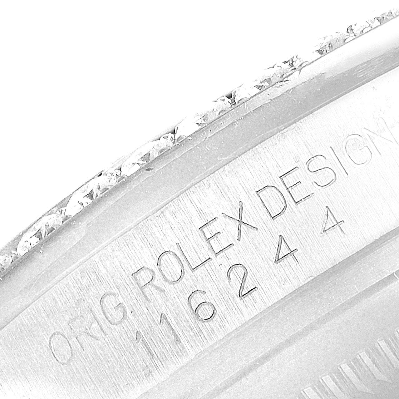 The image shows an angled close-up of the engraved serial number and part of the bezel of a Rolex Datejust 116244 Men's Stainless Steel Mother of Pearl Dial 116244 Men's Stainless Steel Mother of Pearl Dial watch.