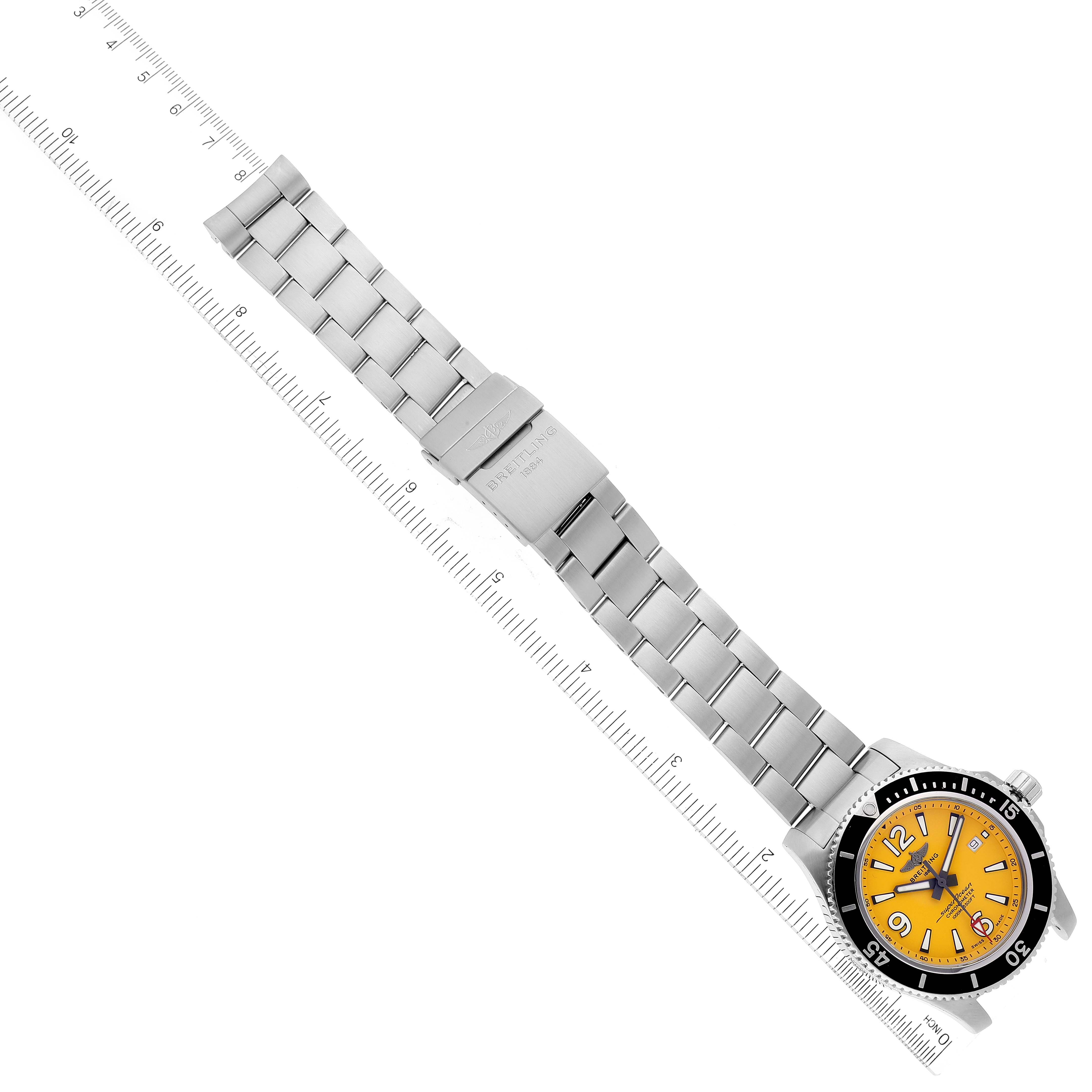The image shows a Breitling Superocean A17367021I1A1 Men's Stainless Steel Yellow Dial A17367021I1A1 Men's Stainless Steel Yellow Dial watch placed horizontally, displaying its full metal bracelet and clasp, with a yellow dial and black bezel.