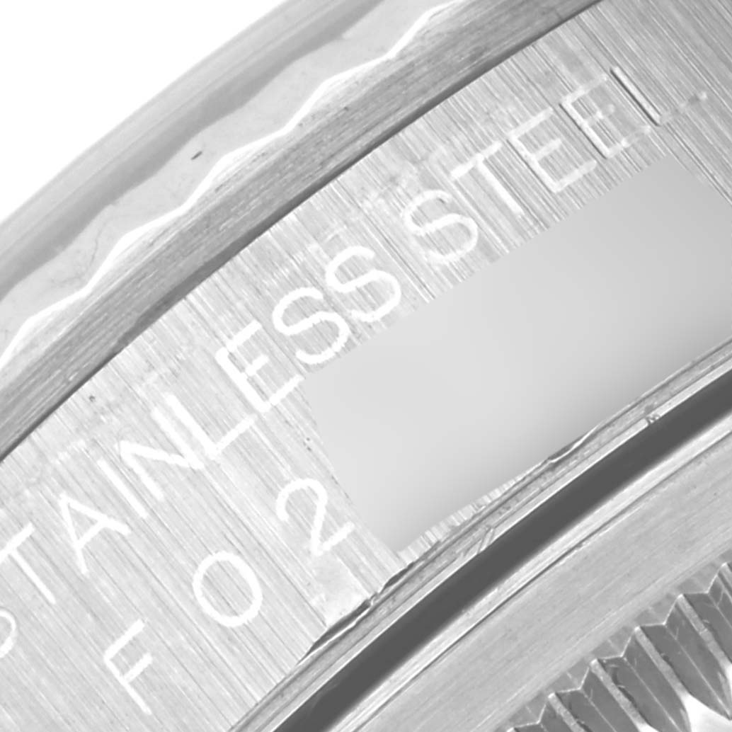 Close-up view of the serial number and part of the bezel of a Rolex Datejust 16234 Men's Stainless Steel Blue Dial 16234 Men's Stainless Steel Blue Dial watch, showing the "STAINLESS STEEL" engraving.