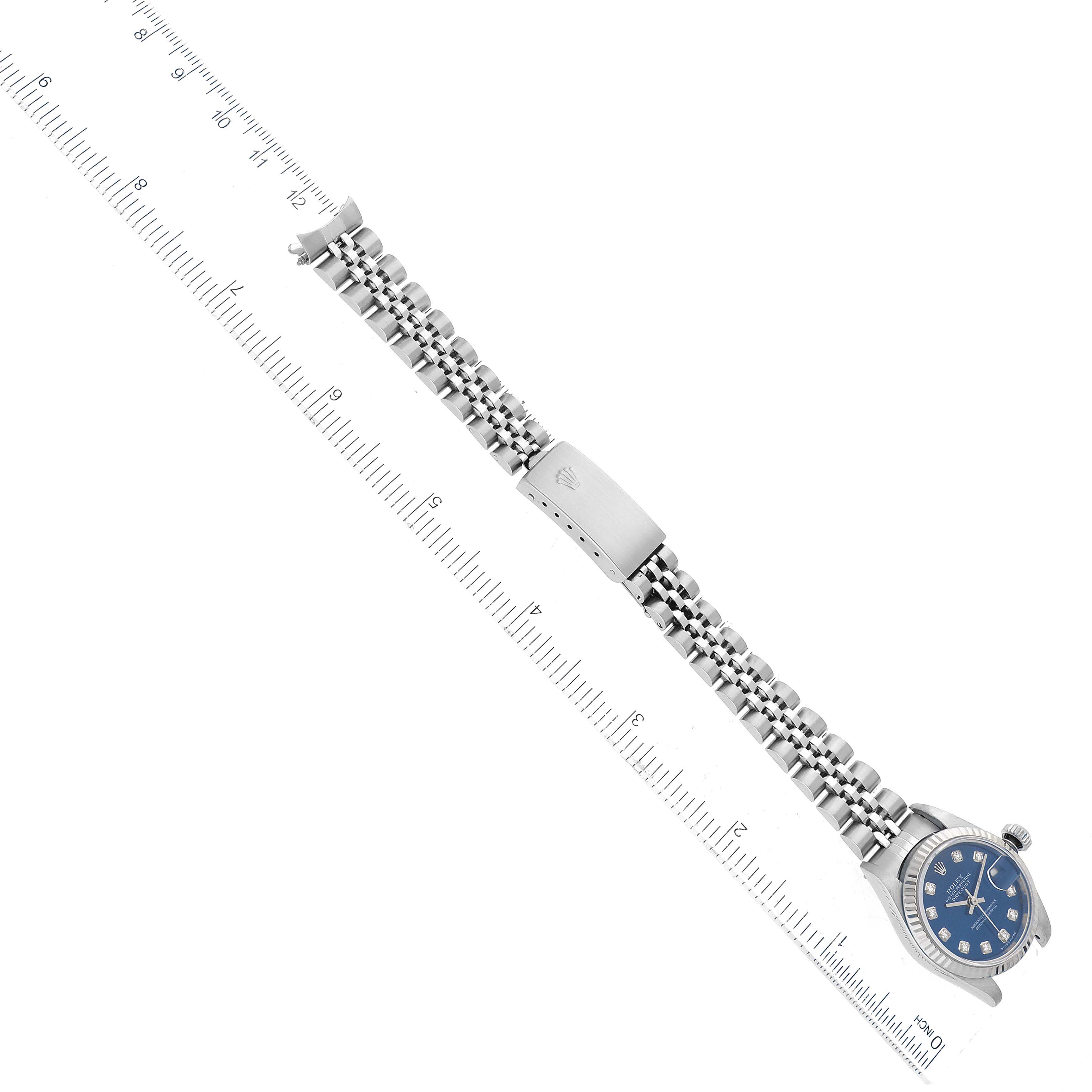 The image shows a Rolex Datejust 79174 Women's Stainless Steel Blue Dial 79174 Women's Stainless Steel Blue Dial watch placed along a ruler, displaying the bracelet, clasp, and partial face from an overhead angle.