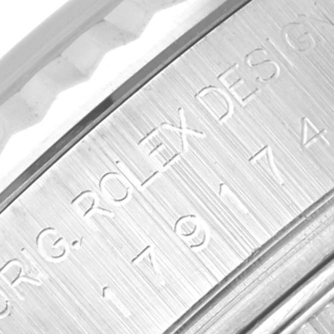 The image shows an angled close-up of the engravings on the case side of a Rolex Datejust 179174 Women's Stainless Steel Black Dial 179174 Women's Stainless Steel Black Dial watch.