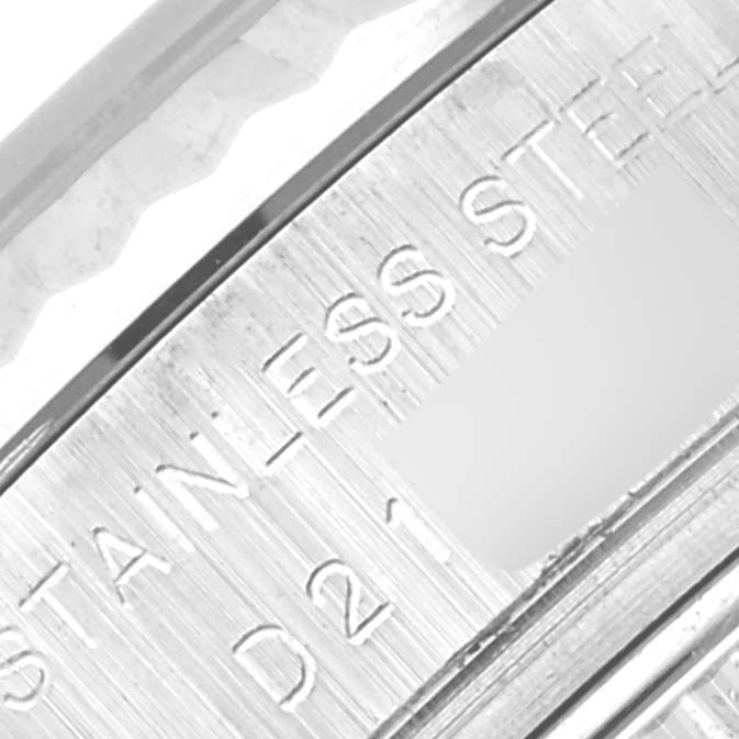 The image shows a close-up of the stainless steel casing edge of a Rolex Datejust 179174 Women's Stainless Steel Black Dial 179174 Women's Stainless Steel Black Dial watch with engraved text.