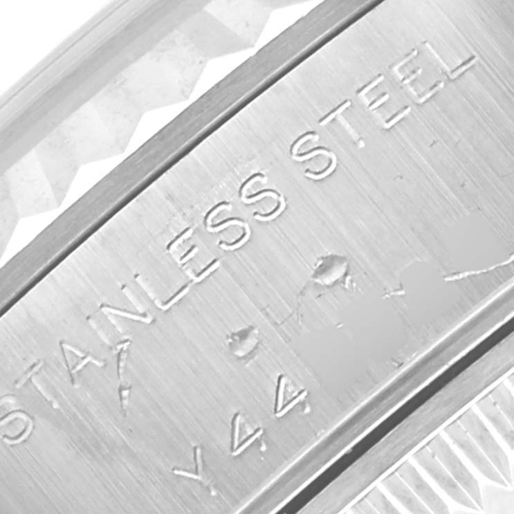 This close-up shot of the Rolex Datejust 79174 Women's Stainless Steel Silver Dial 79174 Women's Stainless Steel Silver Dial watch shows the engraved text indicating "STAINLESS STEEL" and part of the model and serial number.
