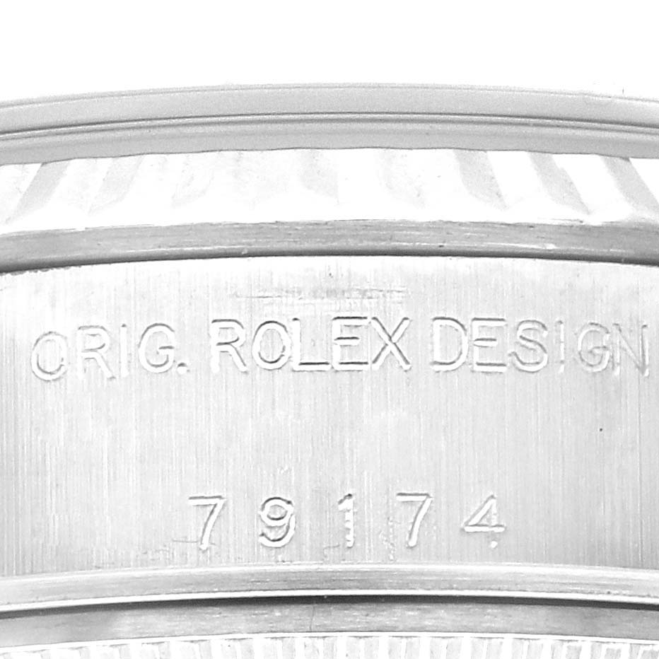This image shows a close-up of the engraved serial number and "ORIG. ROLEX DESIGN" on the case of a Rolex Datejust 79174 Women's Stainless Steel Silver Dial 79174 Women's Stainless Steel Silver Dial watch.