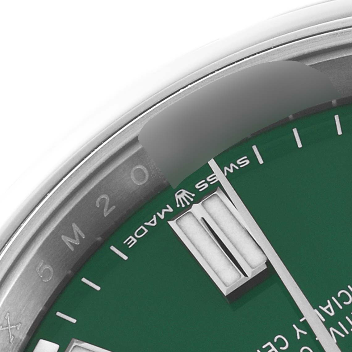 This close-up image shows the dial, bezel, and minute markers of the Rolex Oyster Perpetual 126000 Men's Stainless Steel Green Dial 126000 Men's Stainless Steel Green Dial watch.