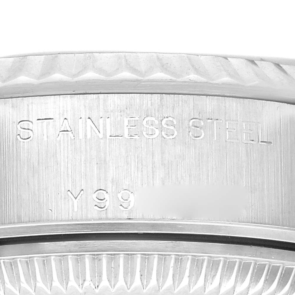 The image shows a close-up of a stainless steel part of the Rolex Datejust 79174 Women's Stainless Steel Pink Dial 79174 Women's Stainless Steel Pink Dial model, including part of the case and bezel.