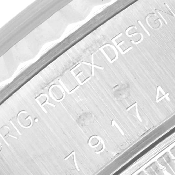 Close-up of the engraving on the side of a Rolex Datejust 79174 Women's Stainless Steel Mother of Pearl Dial 79174 Women's Stainless Steel Mother of Pearl Dial watch case, displaying the model number and the brand name.