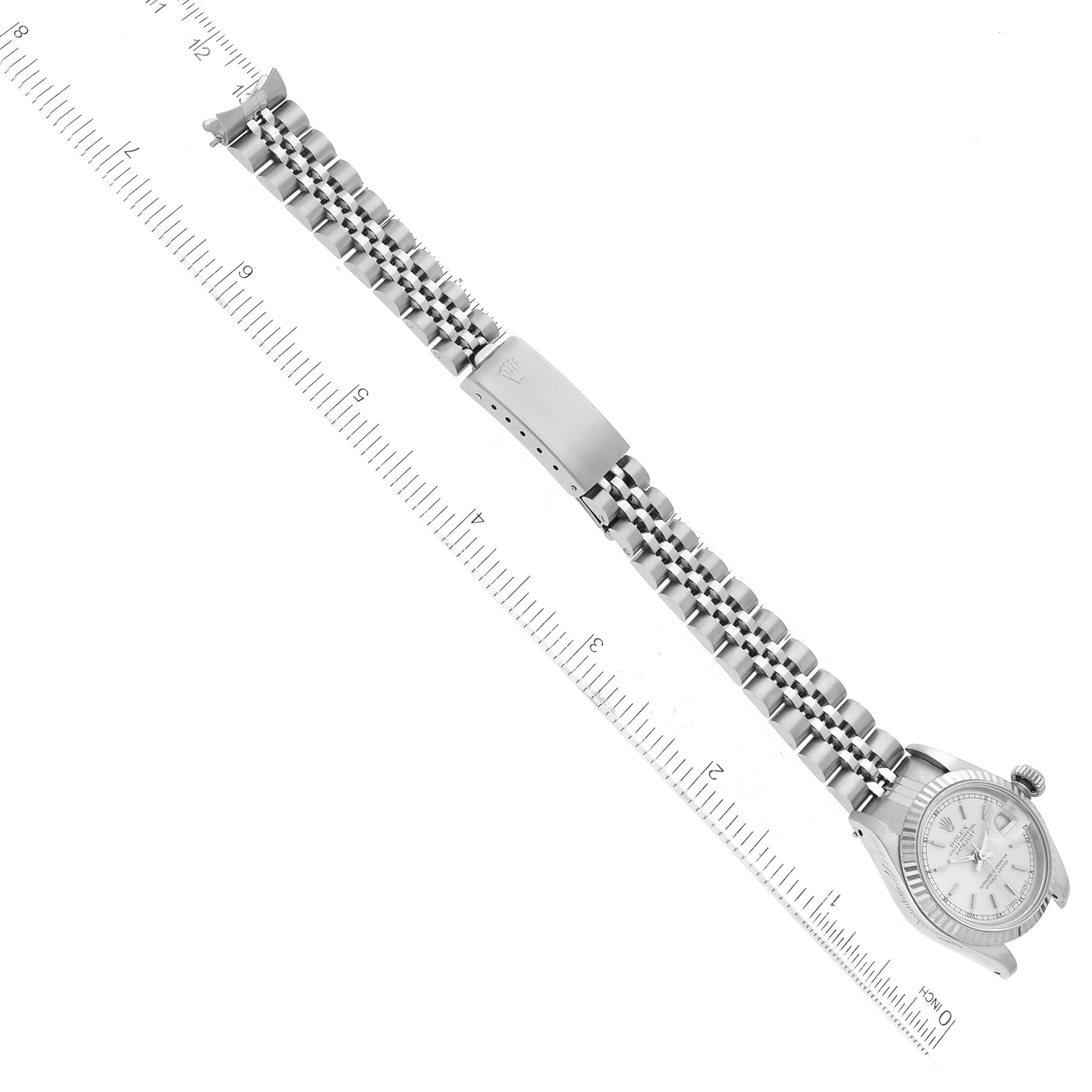 The image shows a full view of a Rolex Datejust 69174 Women's Stainless Steel Silver Dial 69174 Women's Stainless Steel Silver Dial watch laid flat, with the ruler measuring the length of the watch and its bracelet.