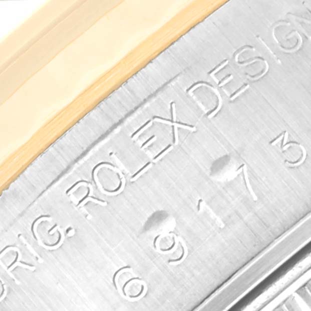 The image shows a close-up of the side of a Rolex Datejust 69173 Women's Steel and Gold (two tone) Champagne Dial 69173 Women's Steel and Gold (two tone) Champagne Dial watch, displaying part of the bezel and engraved text.