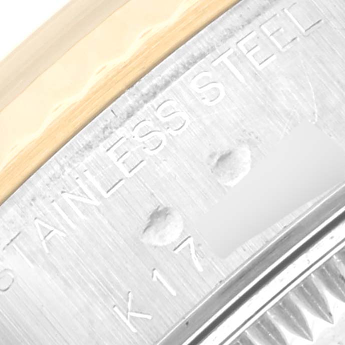 The image shows a close-up of the stainless steel caseback and edge of the bezel of a Rolex Datejust 79173 Women's Steel and Gold (two tone) Mother of Pearl Dial 79173 Women's Steel and Gold (two tone) Mother of Pearl Dial watch.