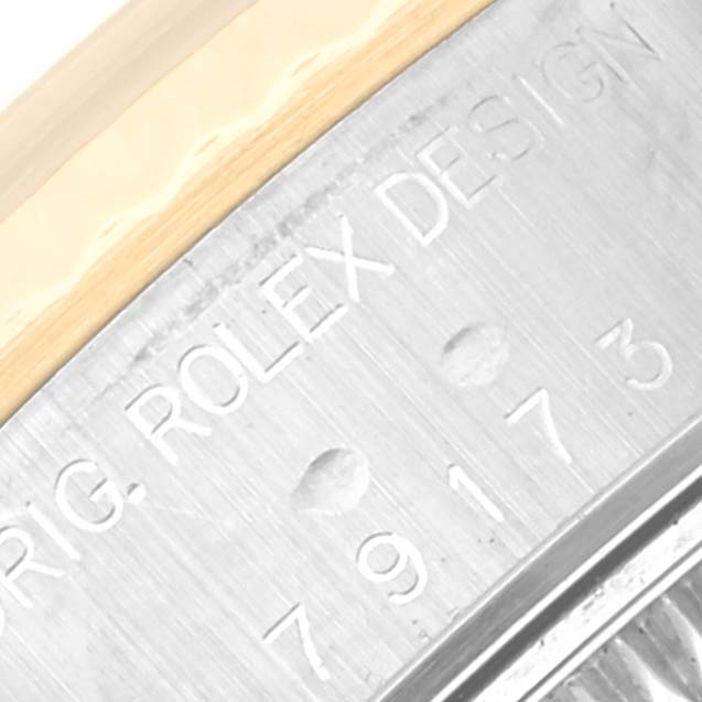 This close-up image shows the engraved model number and part of the bezel of a Rolex Datejust 79173 Women's Steel and Gold (two tone) Mother of Pearl Dial 79173 Women's Steel and Gold (two tone) Mother of Pearl Dial watch.