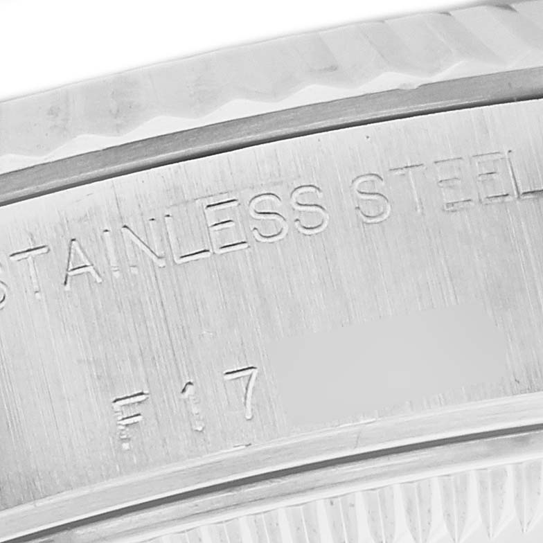 The image shows a close-up of the side of a Rolex Datejust 79174 Women's Stainless Steel Mother of Pearl Dial 79174 Women's Stainless Steel Mother of Pearl Dial watch, focusing on the stainless steel inscription.