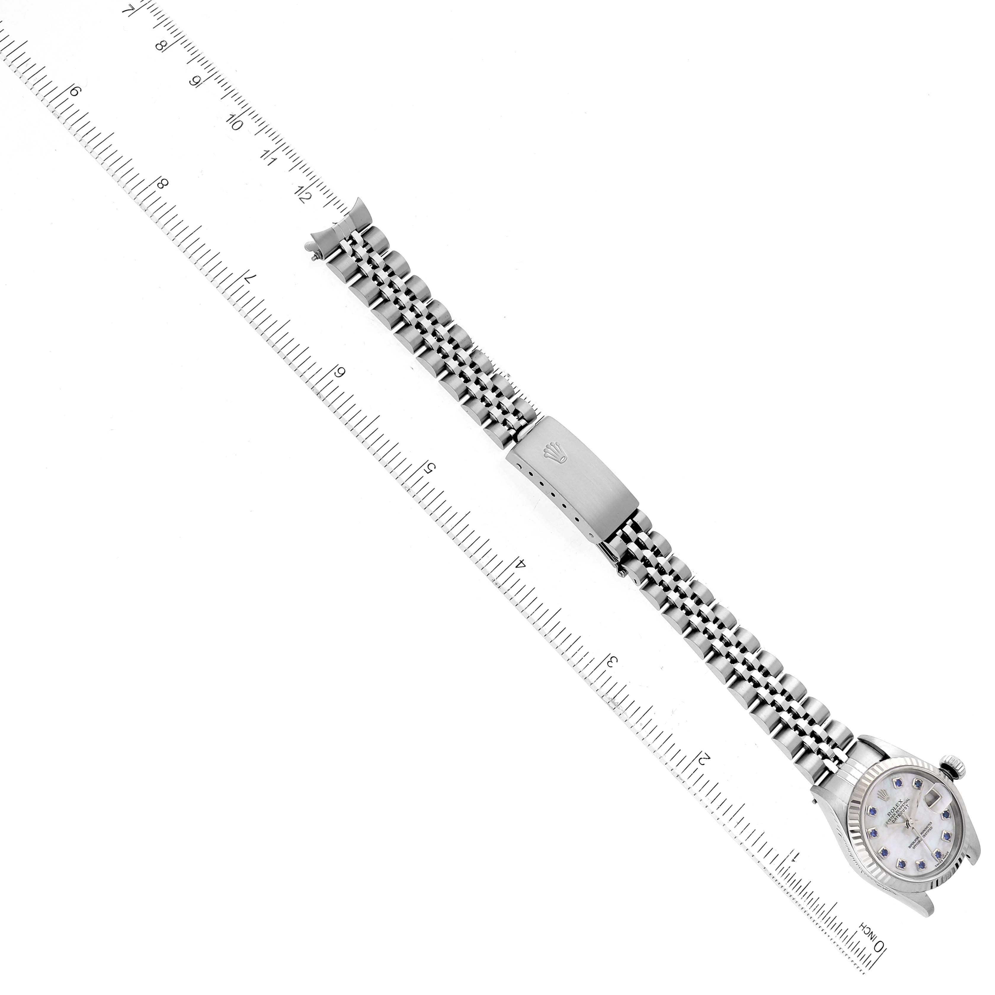 This image shows a top-down view of a Rolex Datejust 79174 Women's Stainless Steel Mother of Pearl Dial 79174 Women's Stainless Steel Mother of Pearl Dial watch, including its dial, bracelet, and clasp, alongside a measuring scale.