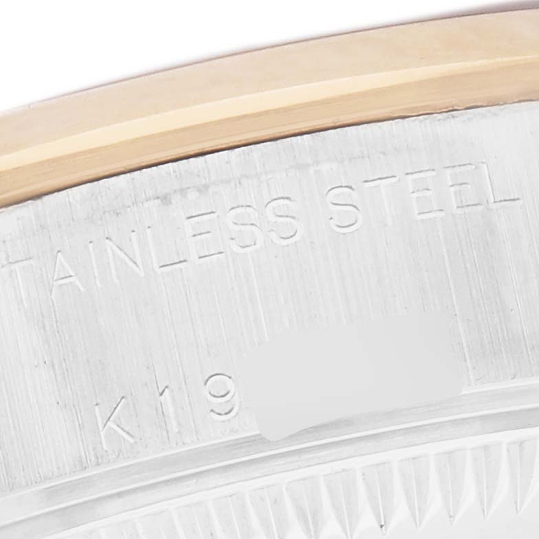 The image shows a close-up of the stainless steel case edge of a Rolex Datejust 79163 Women's Steel and Gold (two tone) Mother of Pearl Dial 79163 Women's Steel and Gold (two tone) Mother of Pearl Dial, highlighting the material engraving.