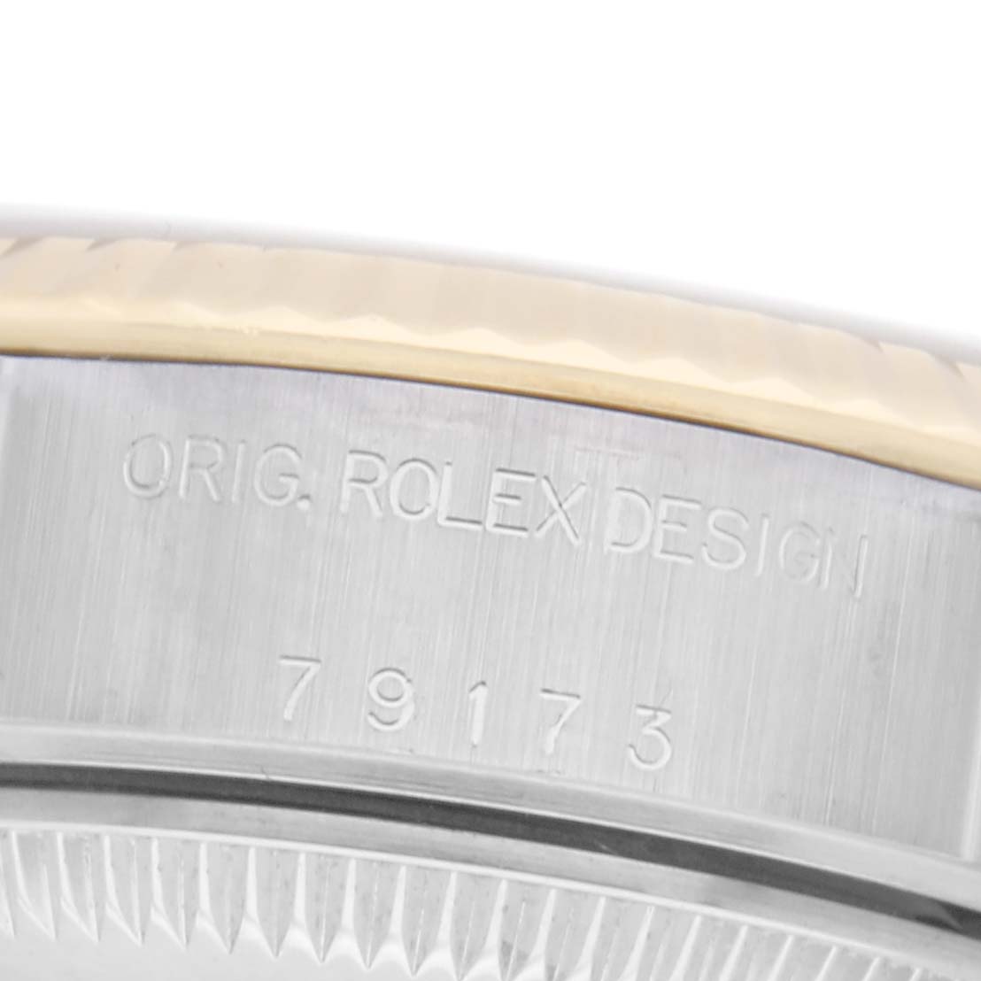 The image shows a close-up of the side of the Rolex Datejust 79173 Women's Steel and Gold (two tone) Silver Dial 79173 Women's Steel and Gold (two tone) Silver Dial, highlighting the "ORIG. ROLEX DESIGN" and model number engraving.