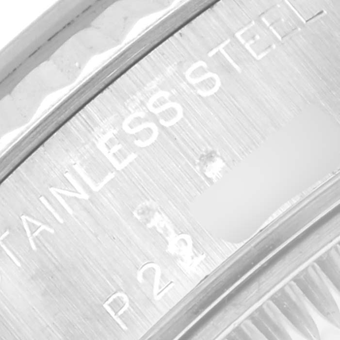 The image shows an extreme close-up of the engraved text on the stainless steel back of a Rolex Datejust 79174 Women's Stainless Steel Mother of Pearl Dial 79174 Women's Stainless Steel Mother of Pearl Dial watch.