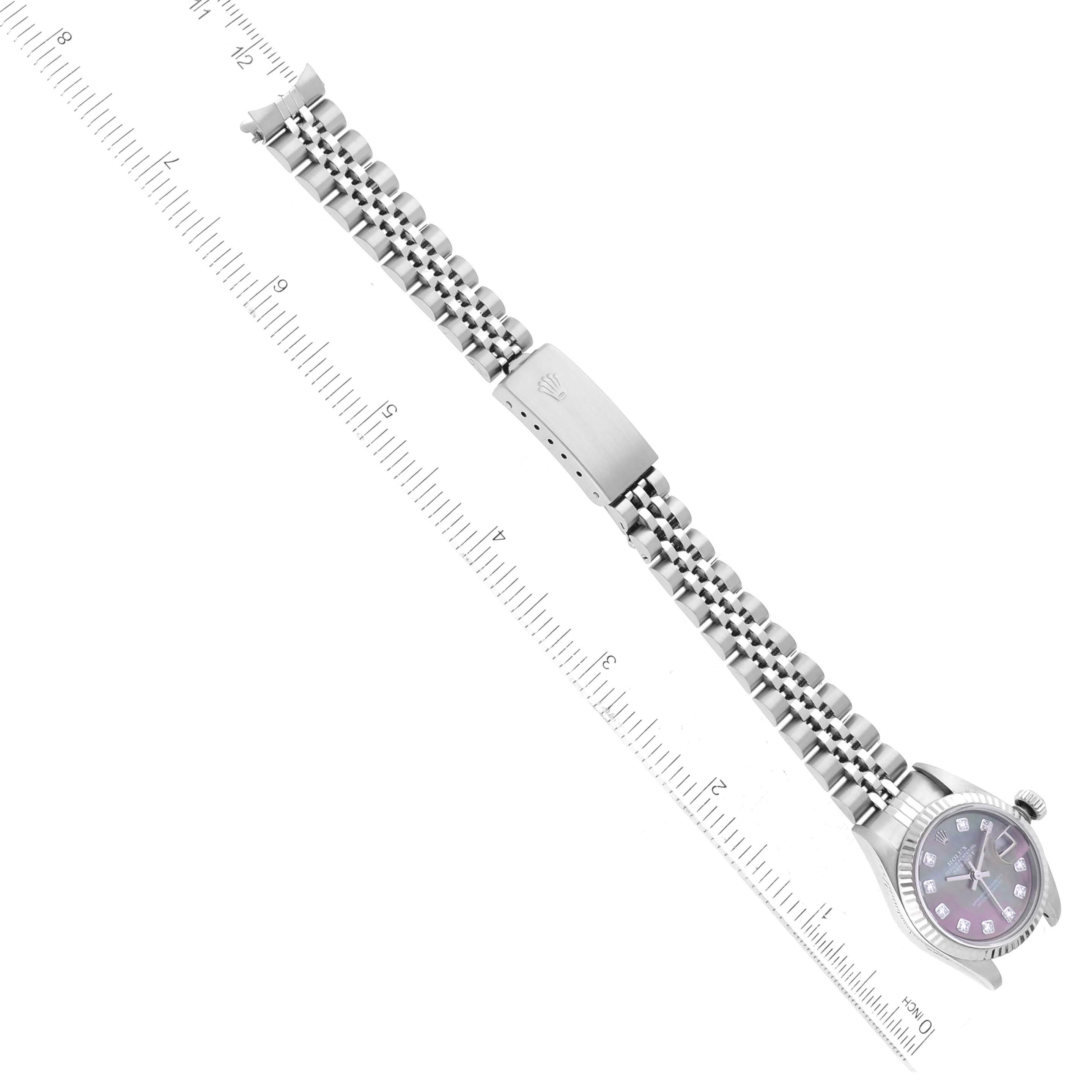 The Rolex Datejust 79174 Women's Stainless Steel Mother of Pearl Dial 79174 Women's Stainless Steel Mother of Pearl Dial watch is shown in an angled top-down view with the full bracelet and clasp visible alongside a measuring ruler.