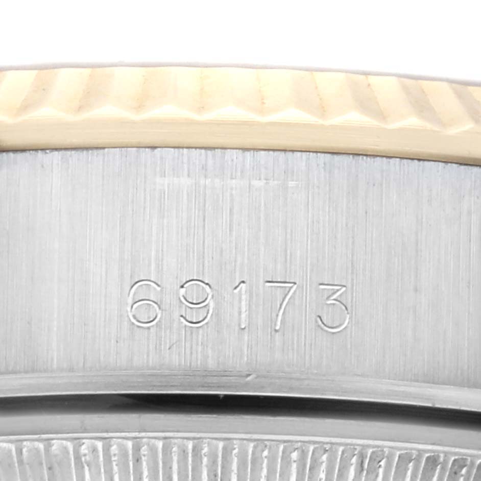 The image shows a close-up of the side of a Rolex Datejust 69173G Women's Steel and Gold (two tone) Champagne Dial 69173G Women's Steel and Gold (two tone) Champagne Dial watch, focusing on the model number 69173 and the fluted bezel.