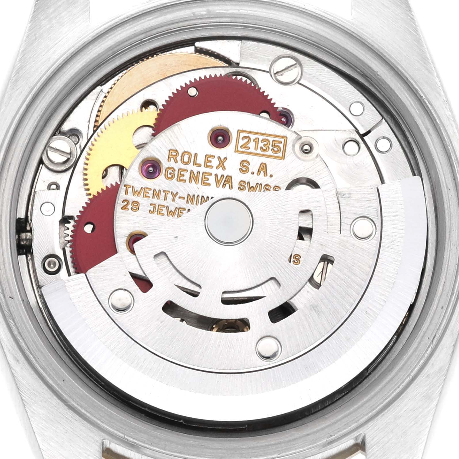 The image shows a close-up view of the movement inside the Rolex Datejust 69173G Women's Steel and Gold (two tone) Champagne Dial 69173G Women's Steel and Gold (two tone) Champagne Dial, featuring gears and the rotor.