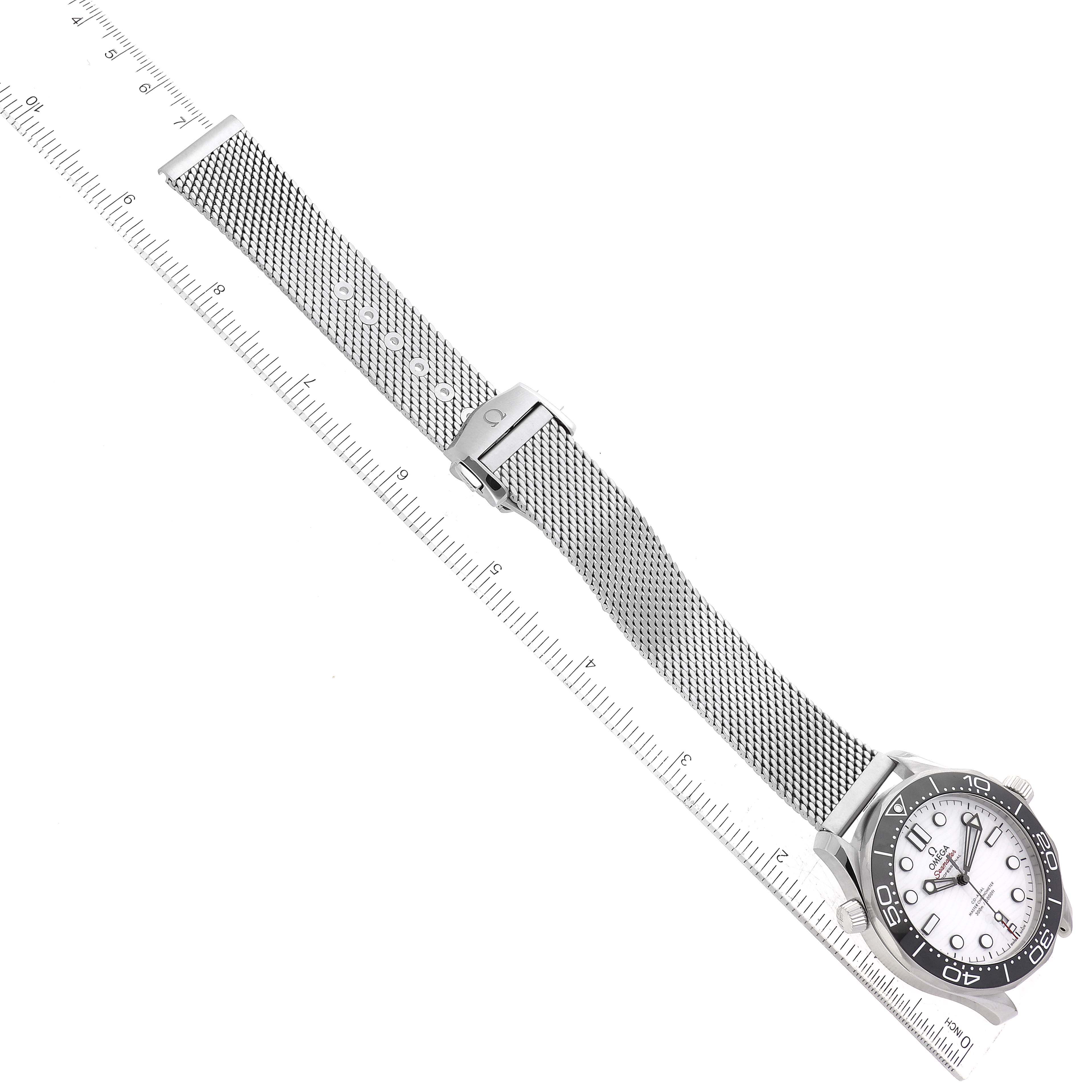 The image shows an Omega Seamaster 210.32.42.20.04.001 Men's Stainless Steel White Dial 210.32.42.20.04.001 Men's Stainless Steel White Dial watch laid flat with a mesh strap and placed next to a ruler for measurement.
