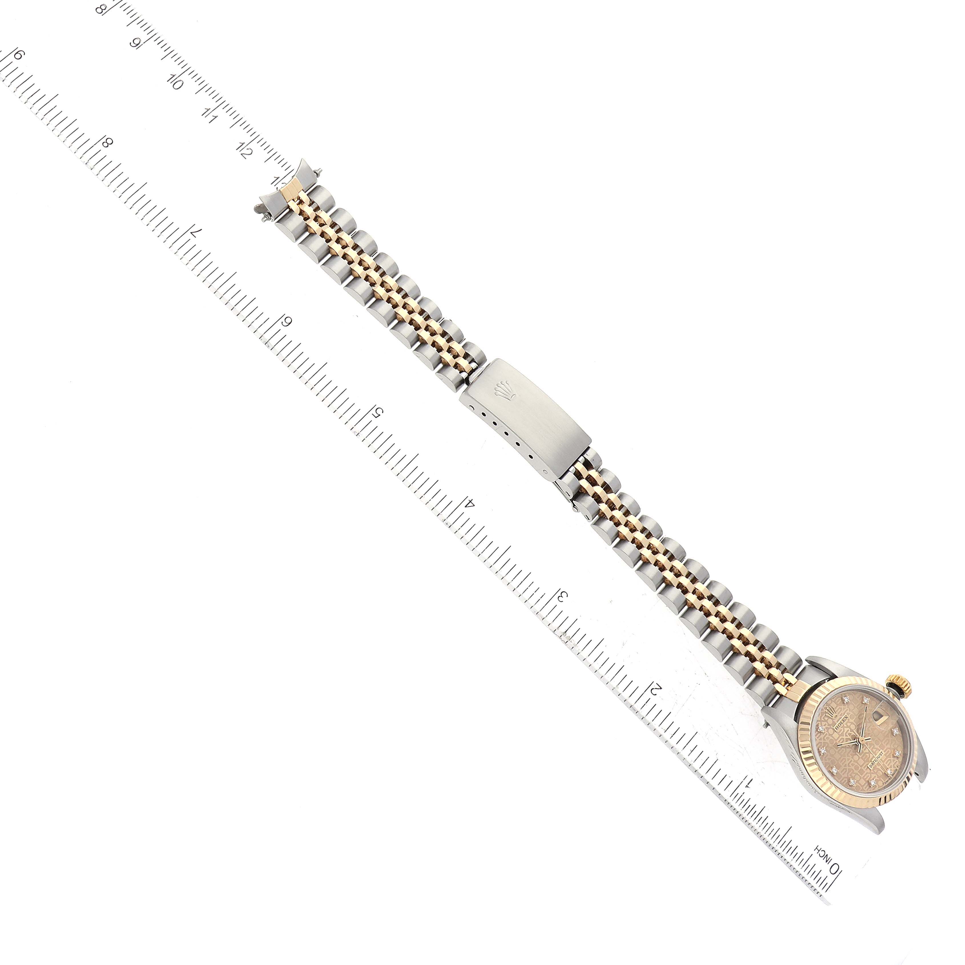 The image shows a top-down view of a Rolex Datejust 69173 Women's Steel and Gold (two tone) Champagne Dial 69173 Women's Steel and Gold (two tone) Champagne Dial watch, highlighting the dial, bezel, bracelet, and clasp, alongside a ruler for scale.