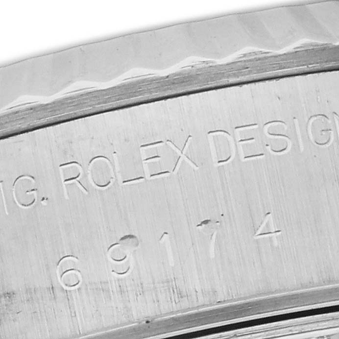This image shows a close-up of the serial number engraving on the case back of a Rolex Datejust 69174 Women's Stainless Steel Pink Dial 69174 Women's Stainless Steel Pink Dial watch.