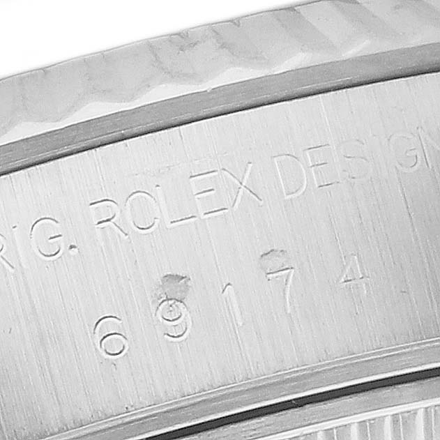 The image shows a close-up of the serial number engraving on the back side of a Rolex Datejust 69174 Women's Stainless Steel Pink Dial 69174 Women's Stainless Steel Pink Dial watch.