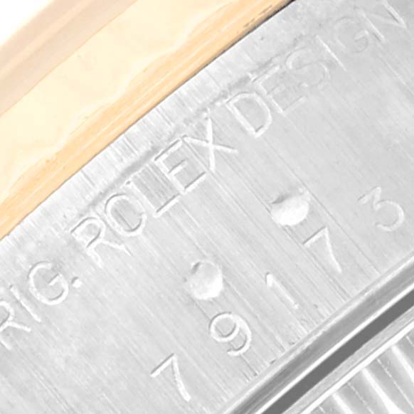 This close-up angle shows the engraved serial number and part of the case of the Rolex Datejust 79173 Women's Steel and Gold (two tone) Champagne Dial 79173 Women's Steel and Gold (two tone) Champagne Dial watch.