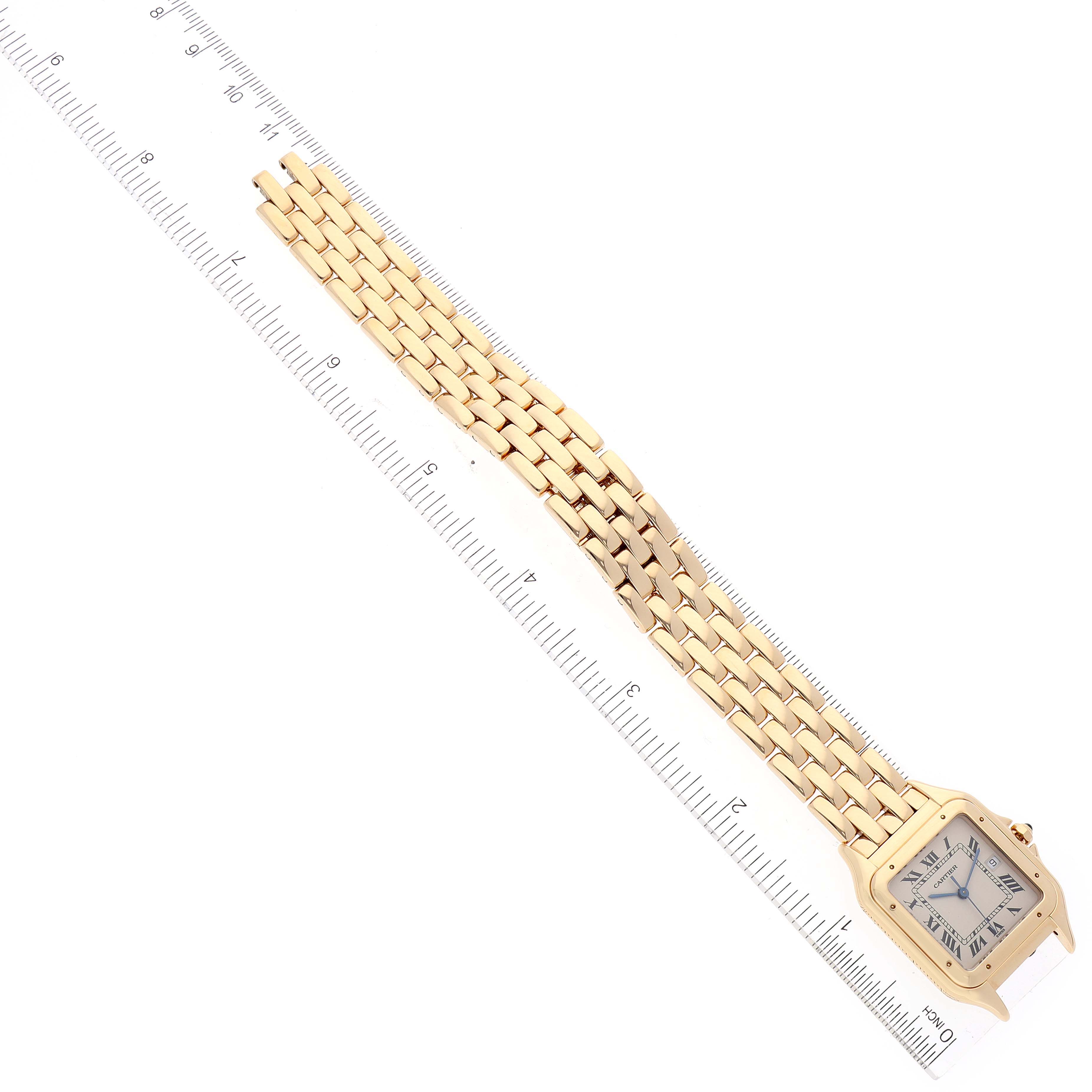 The image shows a gold Cartier Panthere W2501489 Men's Yellow Gold Silver Dial W2501489 Men's Yellow Gold Silver Dial watch with its face and full bracelet displayed alongside a ruler.