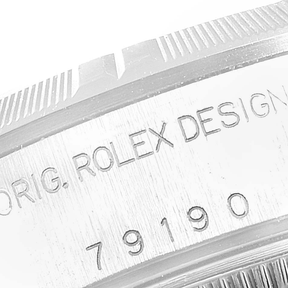 This image shows a close-up of the case side engraving on a Rolex Date 79190 Women's Stainless Steel White Dial 79190 Women's Stainless Steel White Dial model watch.