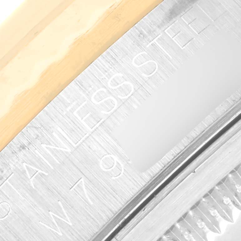 The image shows a macro view of the side of a Rolex Datejust 16233 Men's Steel and Gold (two tone) Champagne Dial 16233 Men's Steel and Gold (two tone) Champagne Dial watch, highlighting the stainless steel and gold detailing.