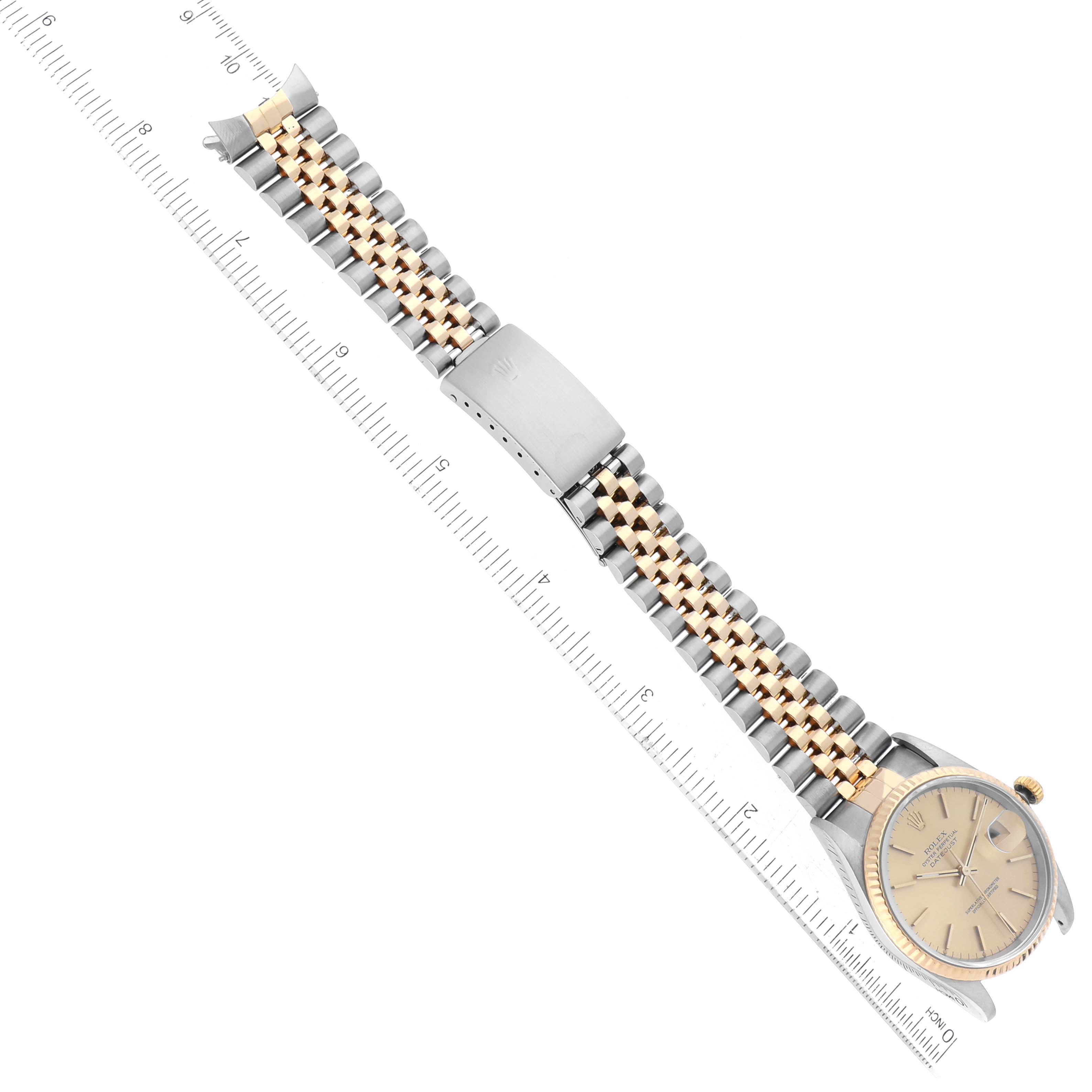 The image shows a Rolex Datejust 16233 Men's Steel and Gold (two tone) Champagne Dial 16233 Men's Steel and Gold (two tone) Champagne Dial watch laid flat, displaying the face, clasp, and two-tone bracelet at an angle.