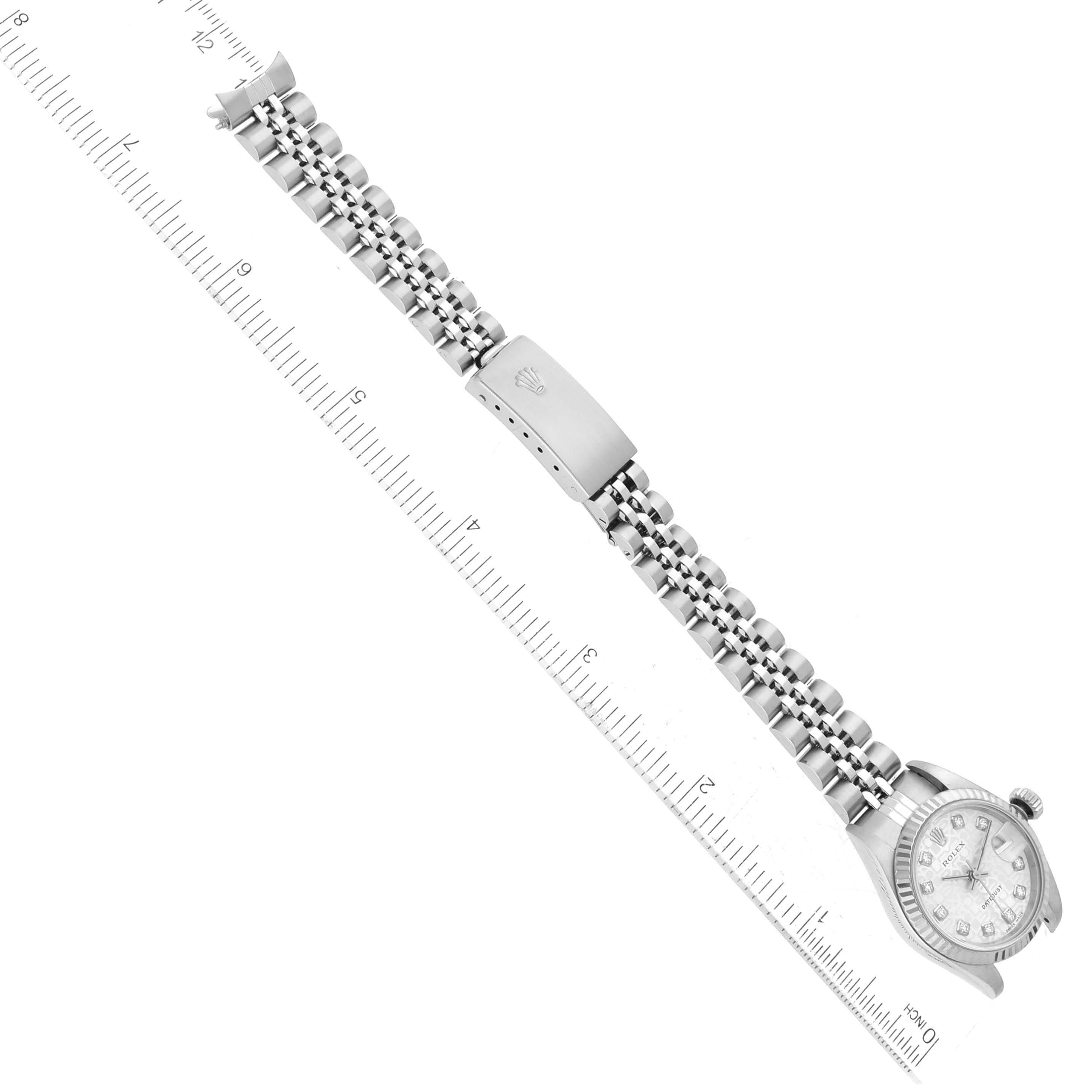 This image shows a Datejust model by Rolex with its full bracelet and clasp, positioned beside a ruler for measurement.