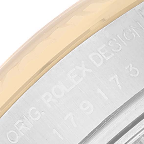 This image shows a close-up of the case side of a Rolex Datejust 179173 Women's Steel and Gold (two tone) Champagne Dial 179173 Women's Steel and Gold (two tone) Champagne Dial, highlighting the engraved serial number and design details.