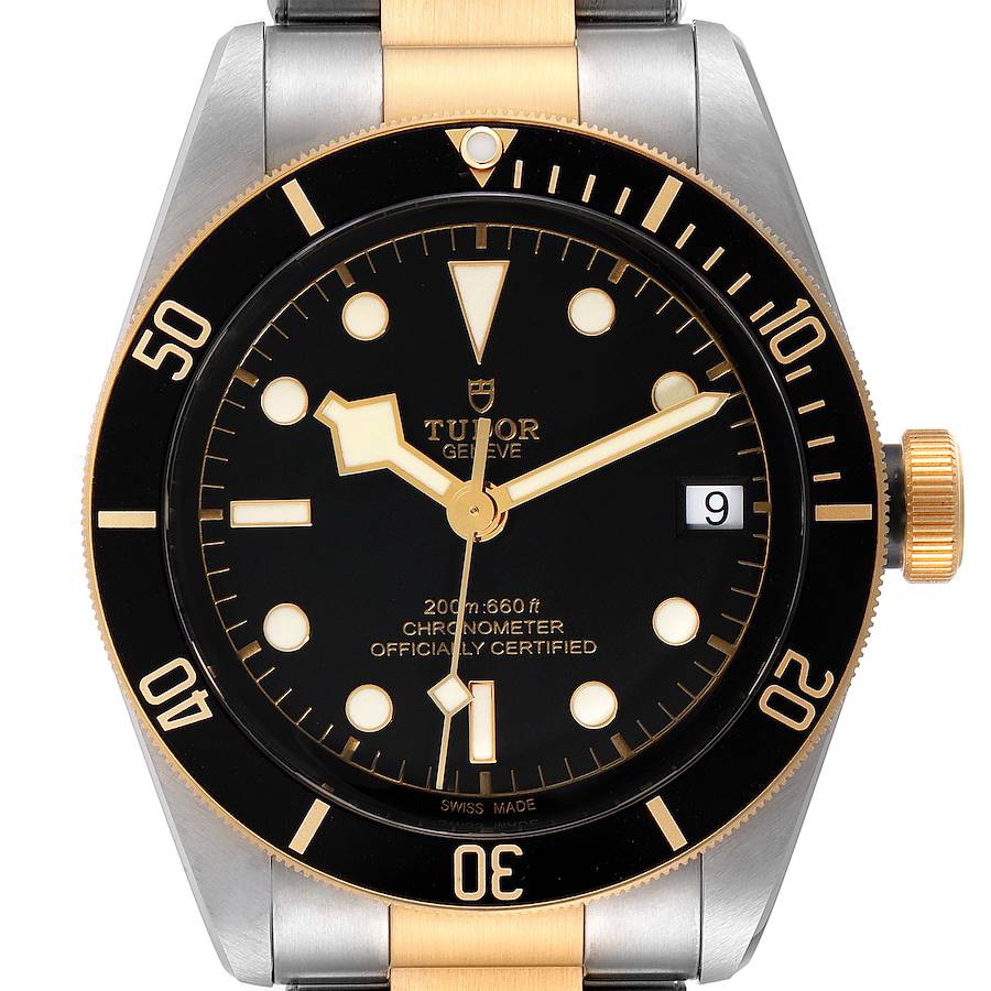 The image shows a front view of the Tudor Heritage Black Bay 79733 Men's Steel and Gold (two tone) Black Dial 79733 Men's Steel and Gold (two tone) Black Dial watch, highlighting the dial, bezel, crown, and part of the bracelet.